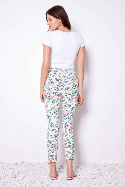 Woman wearing a white t-shirt and floral pants on a white background