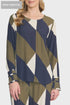 Woman wearing a blue, green, and white patterned top on a white background