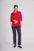 Woman wearing a red sweater and dark pants on a white background