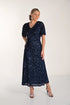 Woman wearing a navy sequin dress on a white background