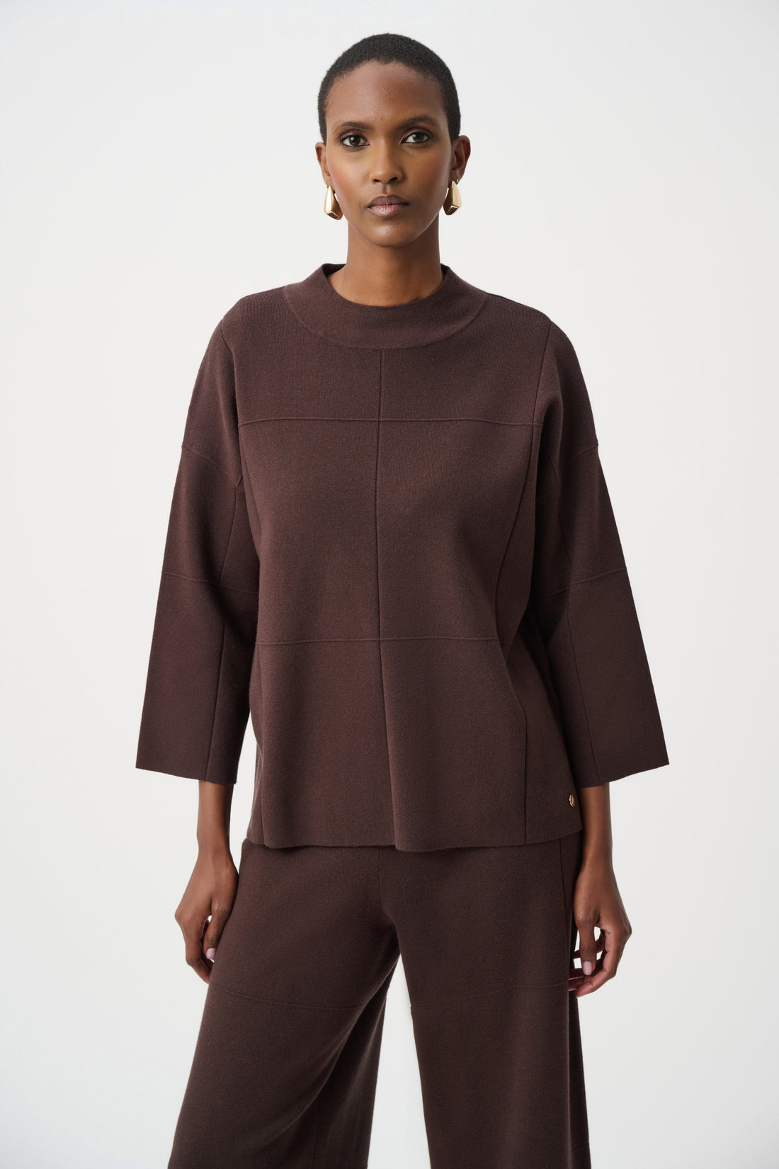 Woman wearing a brown outfit on a white background