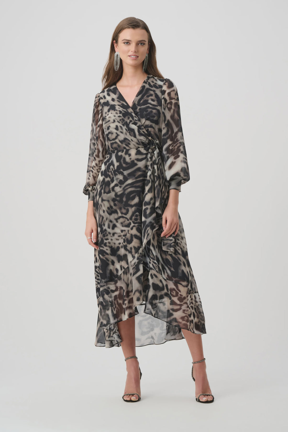 Woman wearing a patterned dress on a white background