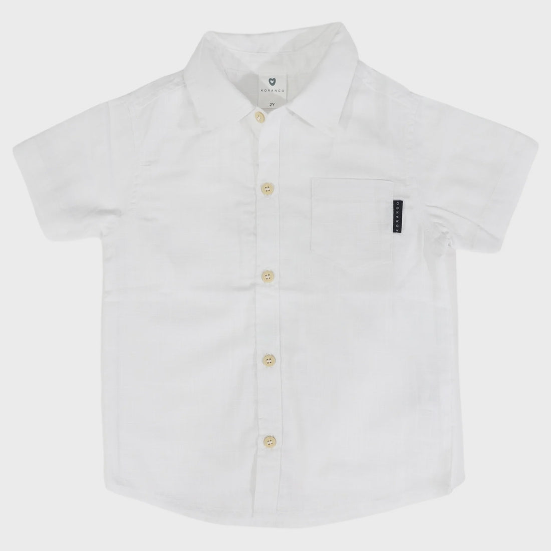 White short-sleeve shirt with buttons on a light gray background