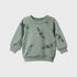 Green sweatshirt with black illustrations on a light gray background