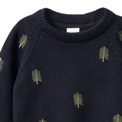 Navy sweater with green leaf patterns on a white background
