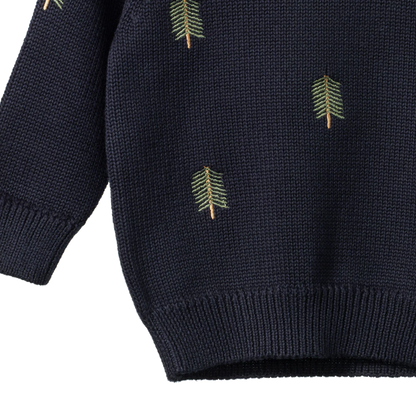 Navy blue sweater with green leaf patterns on a white background