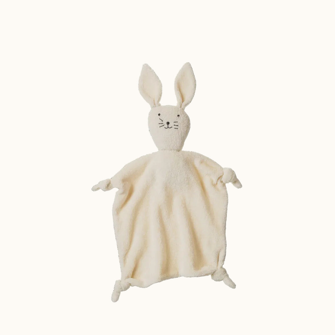 White rabbit-shaped plush toy on a black background
