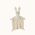 White rabbit-shaped plush toy on a black background