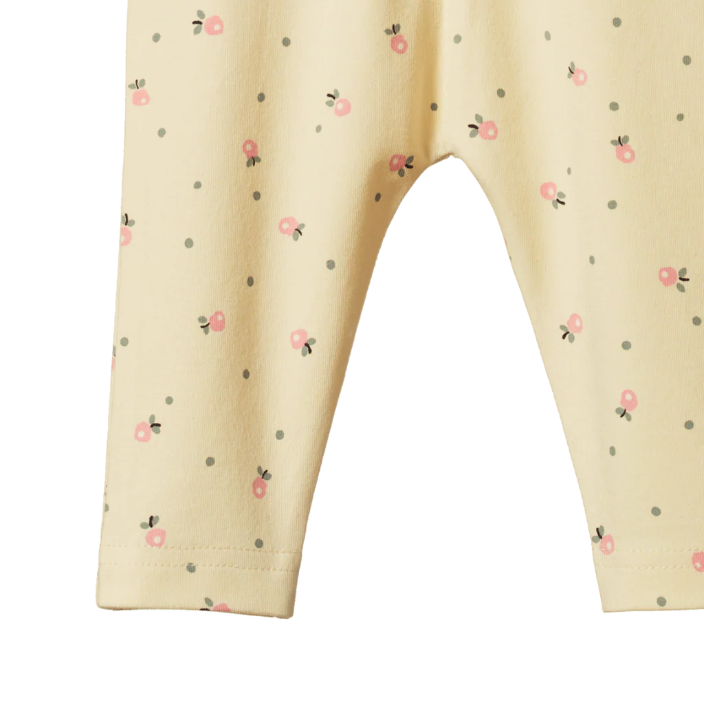 Beige pants with small floral pattern on a white background