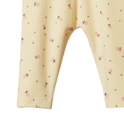 Beige pants with small floral pattern on a white background