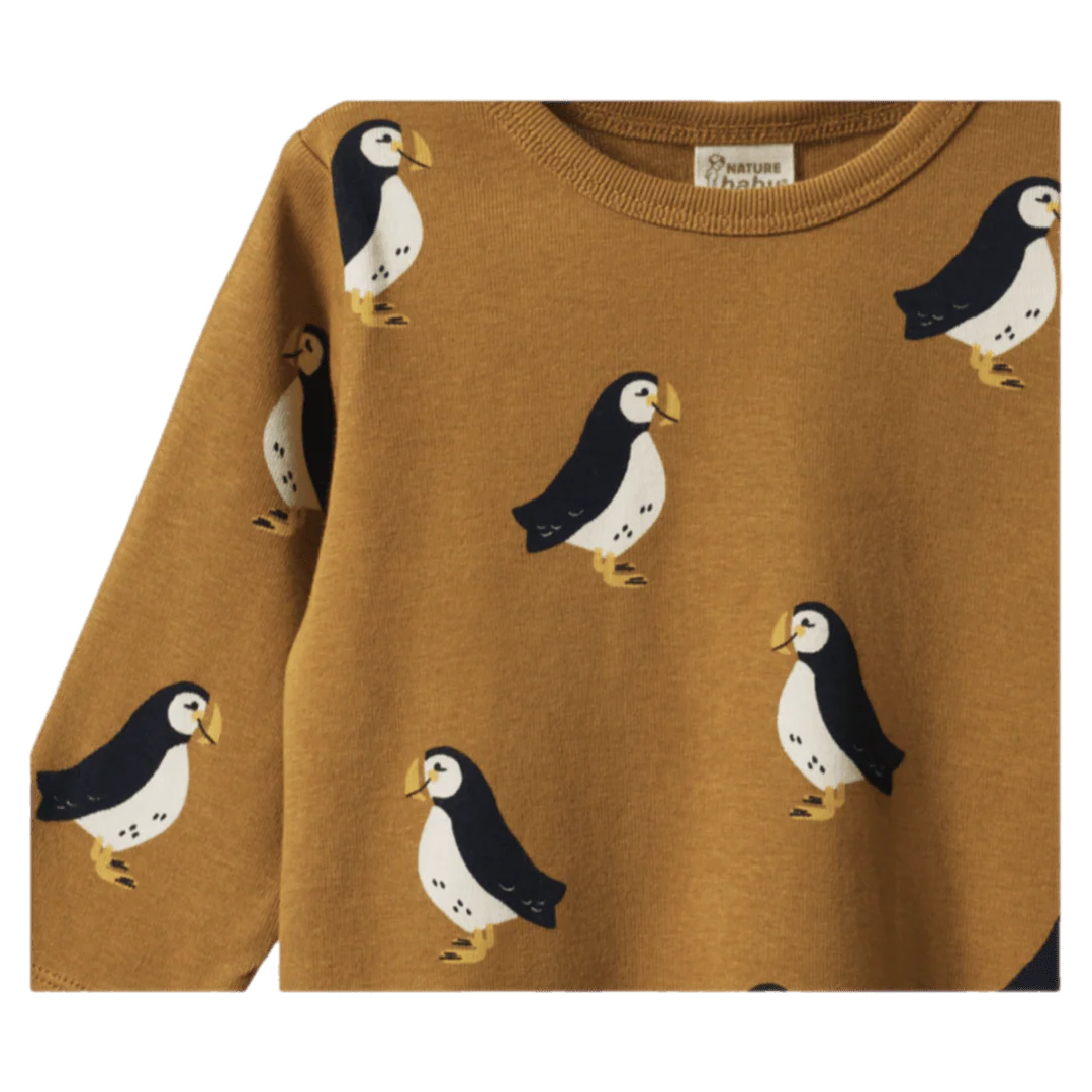 Brown sweater with penguin pattern on a white background