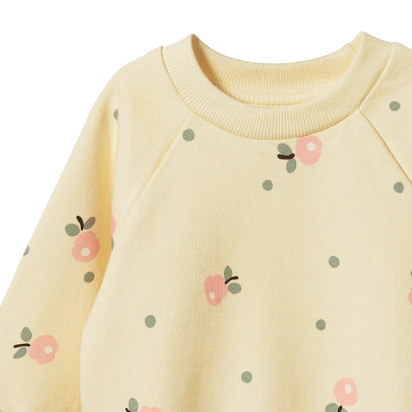 Yellow sweater with floral patterns on a white background