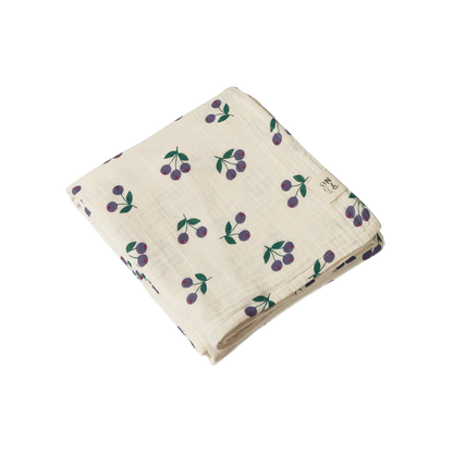 Folded fabric with cherry pattern on a white background