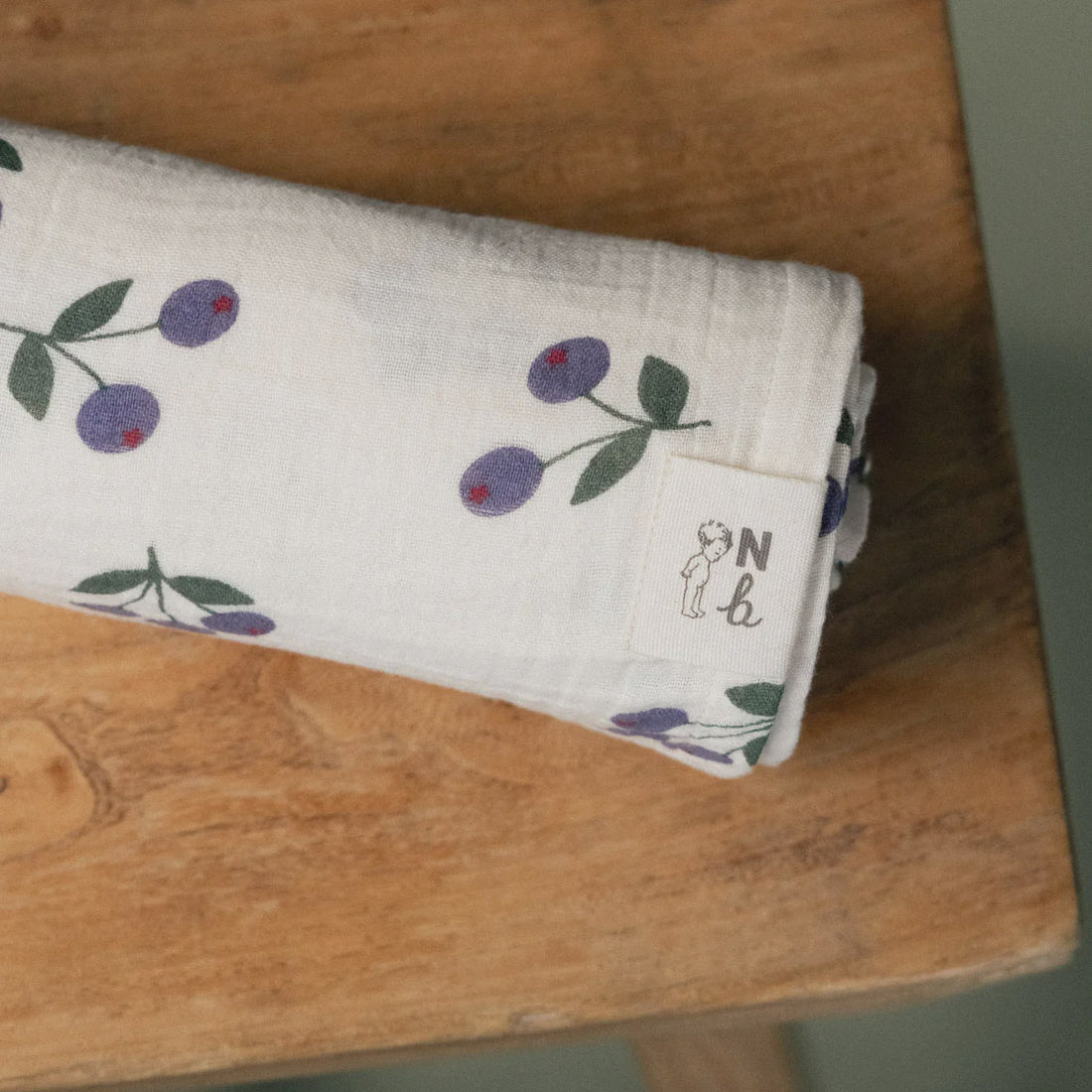Folded fabric with floral pattern on a wooden surface