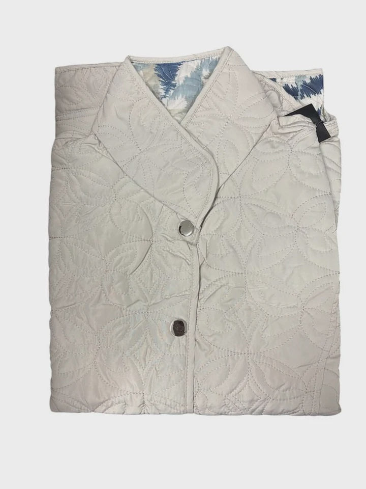 Folded quilt with a floral pattern on a white background