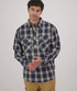 Man wearing a blue plaid shirt on a white background