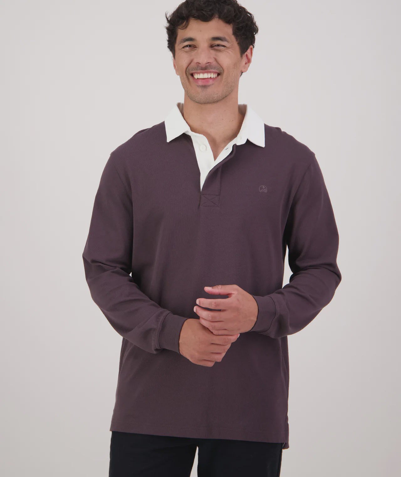 Man wearing a purple long-sleeve shirt with a white collar on a white background