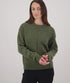 Woman wearing a green knitted sweater on a plain background