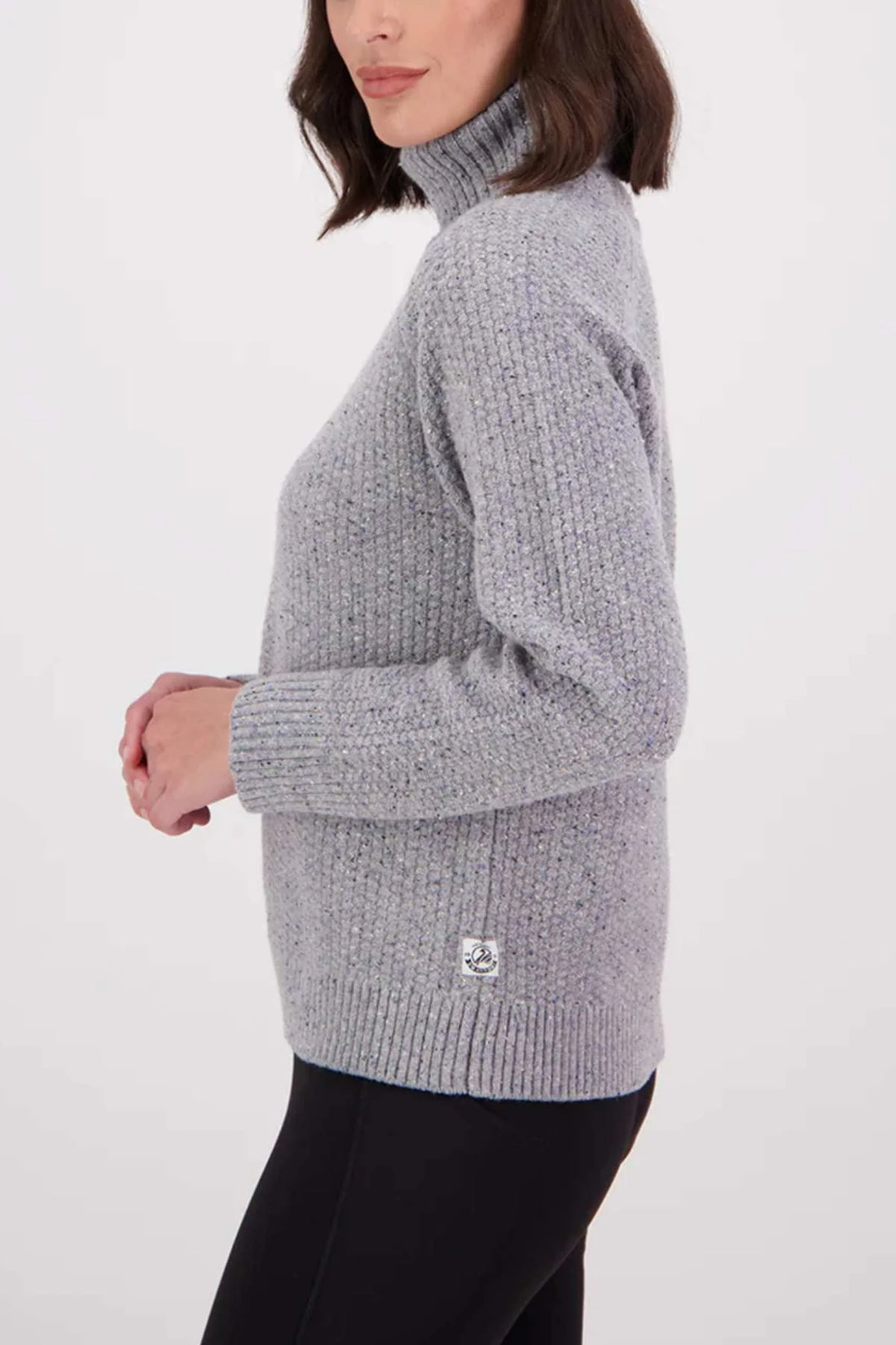 Person wearing a gray knitted sweater on a white background