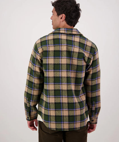 Person wearing a plaid shirt with a white background