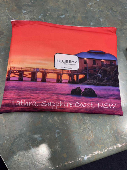 Red pouch with a scenic design of a pier and &