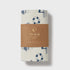 Fitted cot sheet with nautical pattern and brown label on a white background