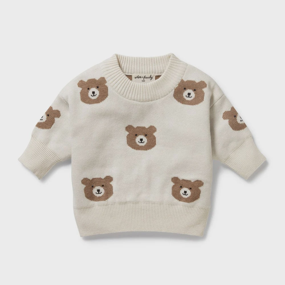 Beige sweater with brown bear patterns on a light gray background