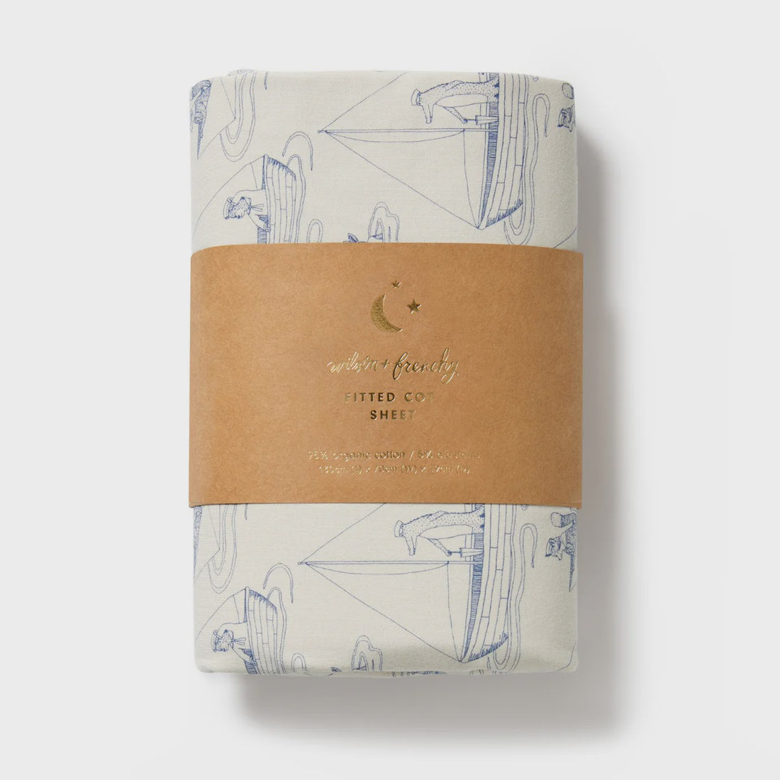 Folded fabric with sailboat pattern and brown label on a white background