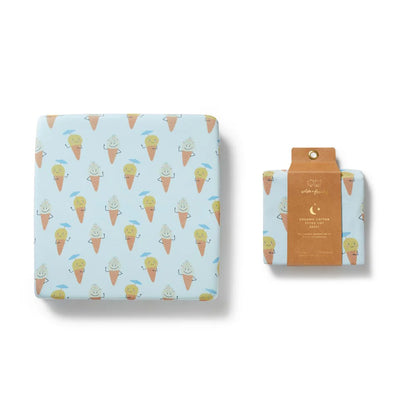 Fitted crib sheet with ice cream cone pattern on a light blue background, displayed with packaging.