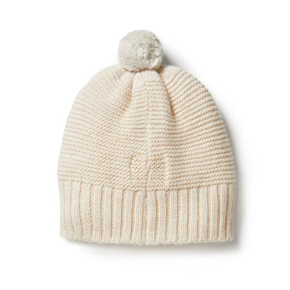 Knitted beanie with a pom-pom on a white background