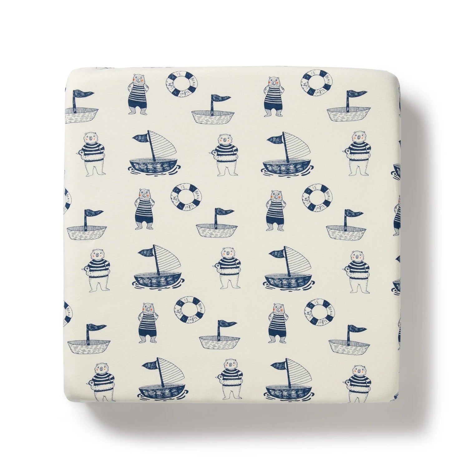 Fitted sheet with nautical pattern featuring bears, boats, and life buoys on a white background