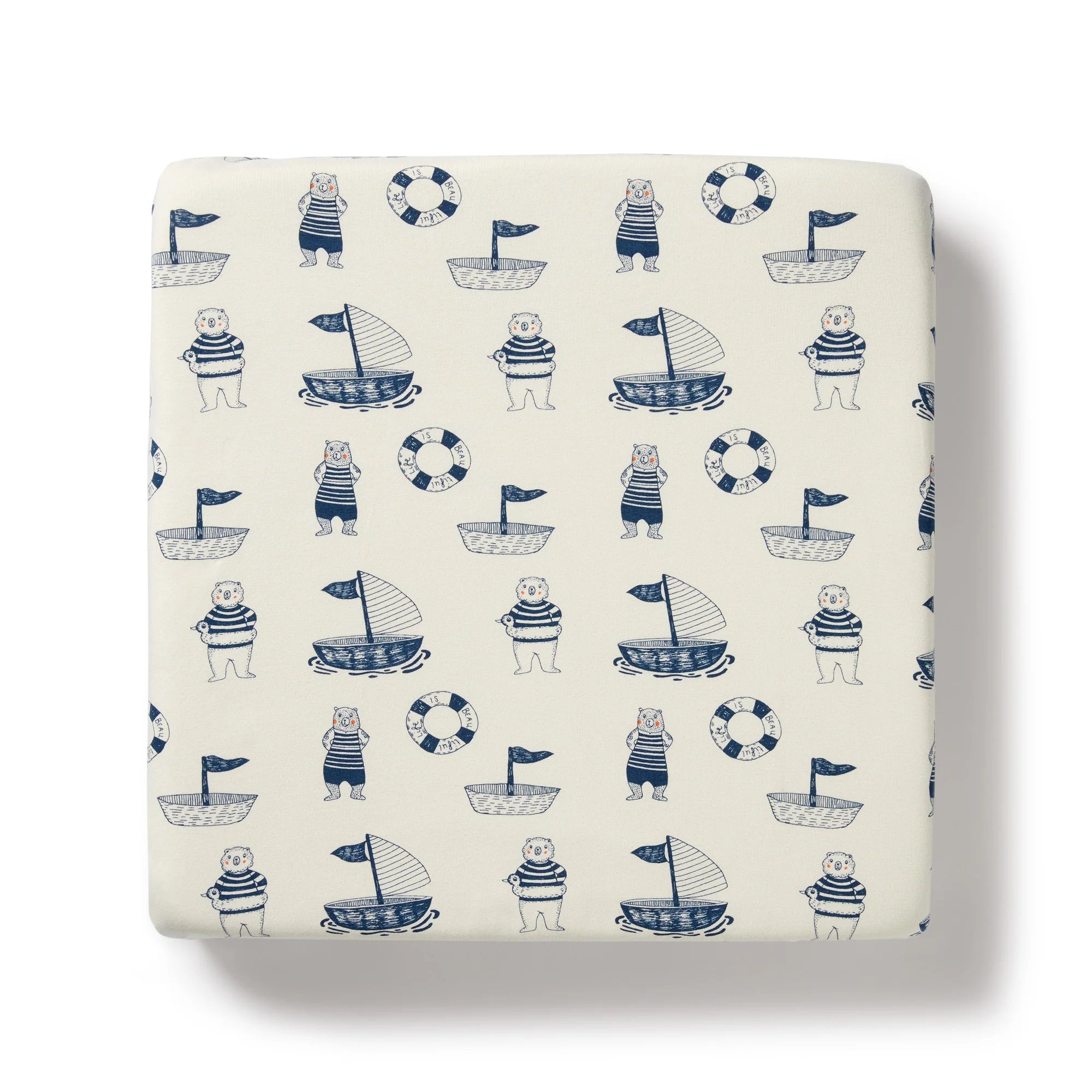 Fitted sheet with nautical pattern featuring bears, boats, and life buoys on a white background