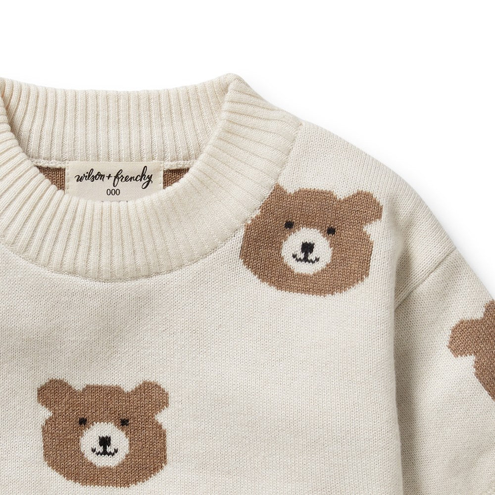 Beige sweater with brown bear patterns on a light gray background